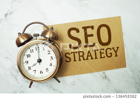 SEO Strategy text written on paper card with alarm clock on marble background 136458382