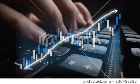 Close-Up View of Fingers Typing on a Keyboard with Overlay of Rising Graph and Financial Data Representing Market Growth Trends and Analytics in Business Copula 136458588