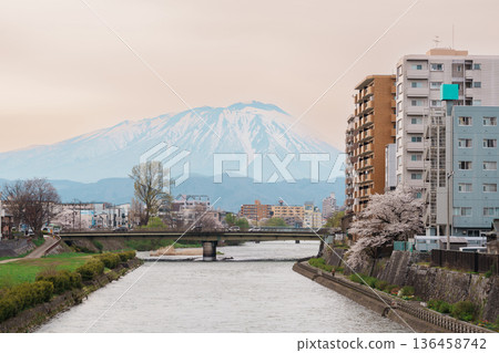 Beautiful Iwate mountain and Kitakami river with flowers blooming in Spring season, cityscape against blue sky in Morioka city, Iwate prefecture, Japan. famous Landmark Travel and Vacation destination 136458742