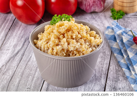 Vegan cuisine - boiled bulgur garnish Vegan cuisine - boiled bulgur garnish 136460106