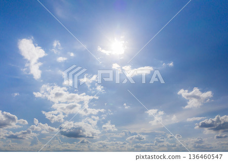 blue sky background with the sun and beautiful white cloud nature background, idea for website or wallpaper background. blue sky background with the sun and beautiful white cloud nature background, idea for website or wallpaper background. 136460547