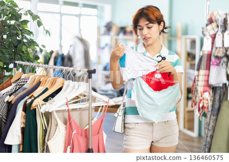 Young woman shopping for new panties in store 136460575
