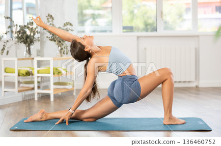 Young girl doing Crescent Low Lunge Pose Anjaneyasana Young girl doing Crescent Low Lunge Pose Anjaneyasana 136460752