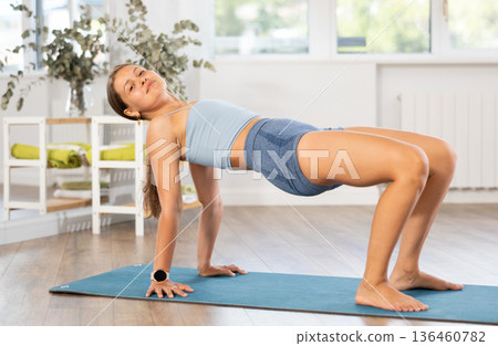 Young woman practicing yoga asanas in studio 136460782