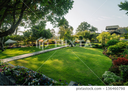 Peaceful garden resort background with walkway and blooming flowers. Peaceful garden resort background with walkway and blooming flowers. 136460798