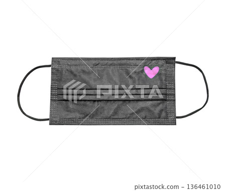 A black protective mask with a pink heart on a white background is a stylish protective accessory. A black protective mask with a pink heart on a white background is a stylish protective accessory. 136461010