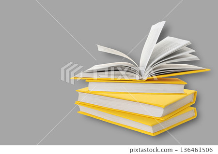 Books are stacked with one open for reading and study Books are stacked with one open for reading and study 136461506
