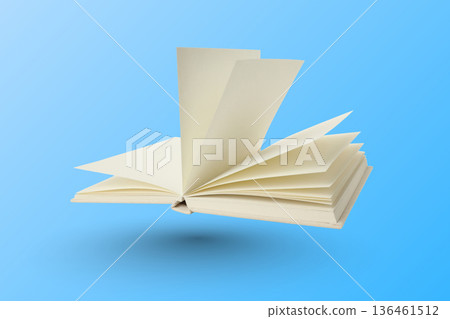 Open book displays empty pages against a blue backdrop 136461512