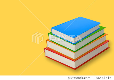 Stack of blank books in different colors on a yellow background Stack of blank books in different colors on a yellow background 136461516