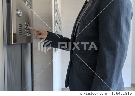 Man pressing an elevator button Man pressing an elevator button 136461810
