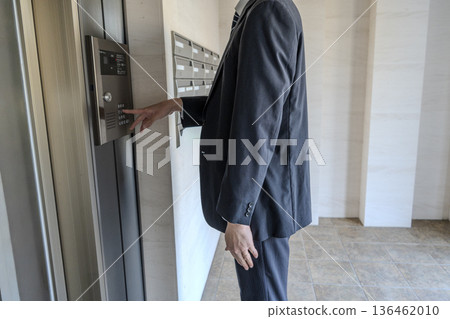 A man riding an elevator A man riding an elevator 136462010