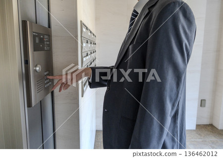 Man pressing an elevator button Man pressing an elevator button 136462012