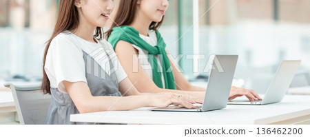 A university student operating a computer in a university classroom 136462200