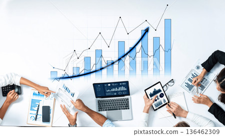 Business Team Collaboration with Performance Graphs and Data Analysis Tools on a Modern Workspace Table Scalp 136462309
