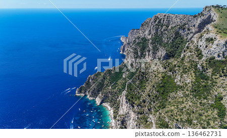 Breathtaking coastal cliffs embrace the azure waters of a serene Italian coastline, capturing the essence of summer tranquility and adventure Breathtaking coastal cliffs embrace the azure waters of a serene Italian coastline, capturing the essence of summer tranquility and adventure 136462731