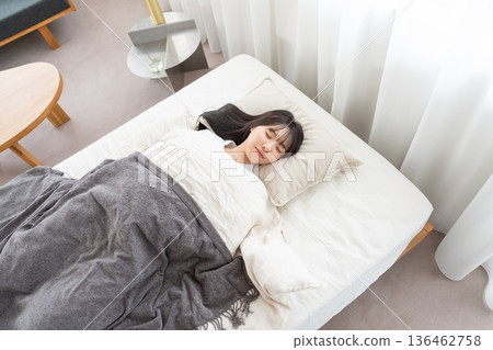 一個睡在床上的年輕女人 136462758