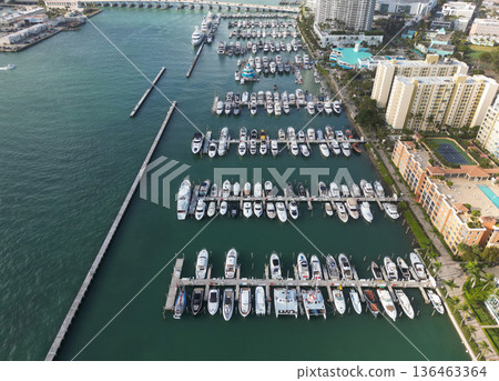 Docked yacht boat in harbor. Luxury summer vacation in Miami. Private boat top view. Marina with luxury sea boat. Yacht club and marina in Miami. Luxury marina with private yacht boat. Coastal marina 136463364