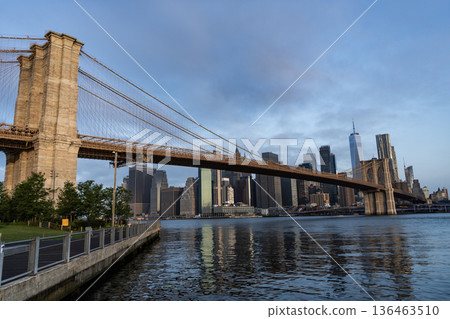 Brooklyn bridge to Manhattan. Urban architecture of New York city. Brooklyn bridge of New York city. Brooklyn landmark. Manhattan cityscape with skyscraper architecture. Hudsson river Brooklyn bridge to Manhattan. Urban architecture of New York city. Brooklyn bridge of New York city. Brooklyn landmark. Manhattan cityscape with skyscraper architecture. Hudsson river 136463510