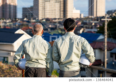 The back view of young and senior workers supporting the site 136464041