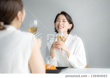 Women having fun drinking at lunch, with mom friends, or with friends at a girls' night out. Cheers! Women having fun drinking at lunch, with mom friends, or with friends at a girls' night out. Cheers! 136464083