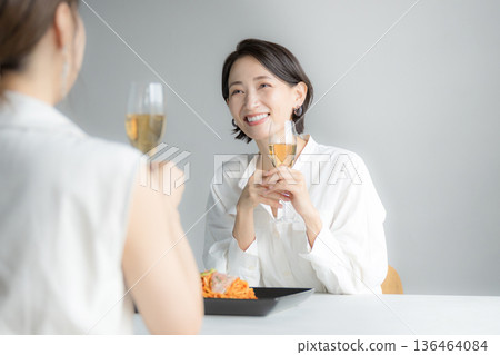 Women having fun drinking at lunch, with mom friends, or with friends at a girls' night out. Cheers! 136464084