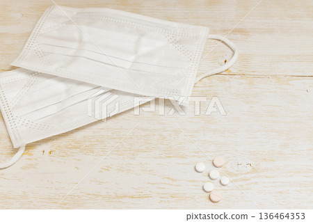 Two nonwoven masks and six pills 136464353
