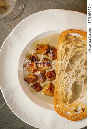 Creamy mushroom soup with toasted bread 136464574