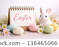 Calendar with Easter text surrounded by holiday symbols, eggs and blossoms. 136465066