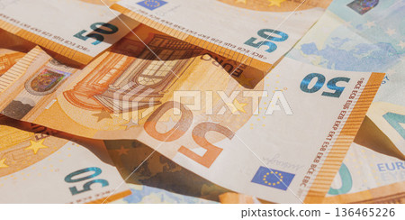 Stack of 50 and 20 Euro banknotes background. European Union currency cash texture. Finance concept 136465226