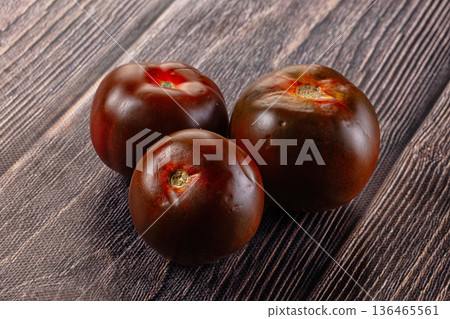 Raw juicy sweet tomato Kumato 136465561