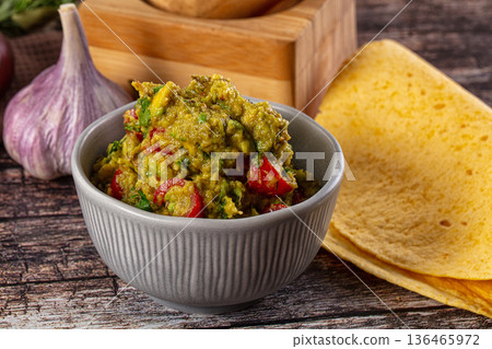 Green spicy Mexican guacamole dip 136465972