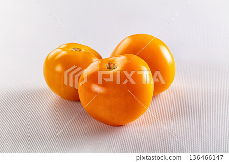 Ripe raw yellow tomato heap Ripe raw yellow tomato heap 136466147