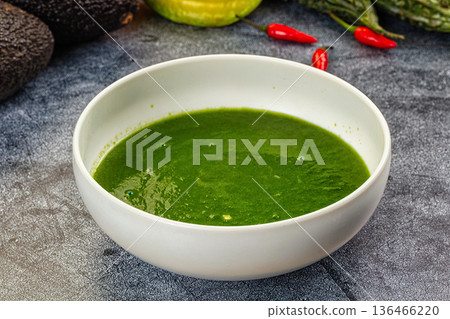 Green Spinach vegetable soup in a bowl with fresh avocado and chili peppers Green Spinach vegetable soup in a bowl with fresh avocado and chili peppers 136466220