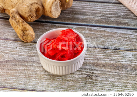 Red marinated sliced ginger roots Red marinated sliced ginger roots 136466290