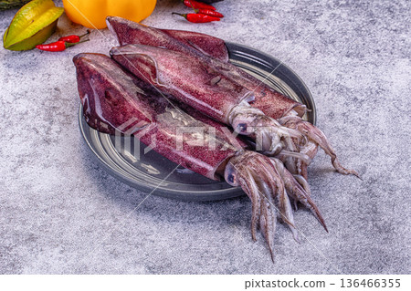 Fresh raw squid on a plate with exotic vegetables for cooking Fresh raw squid on a plate with exotic vegetables for cooking 136466355