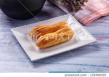 Sweet baked eclair dessert with cream 136466495