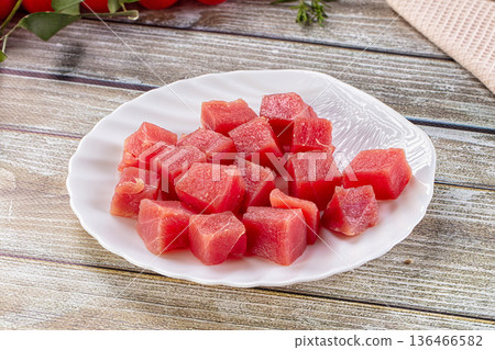 Raw tuna fish cubes heap 136466582