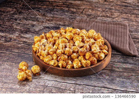 Sweet crunchy popcorn with caramel 136466590