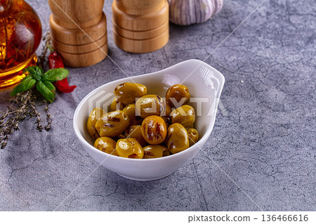 Green grilled olives in oil 136466616