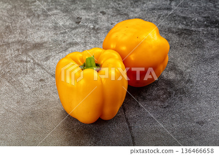 Ripe yellow sweet peppers on a dark textured background 136466658