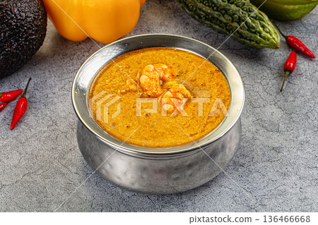 Authentic shrimp curry in a bowl with fresh chili, pepper, and avocado ingredients. Authentic shrimp curry in a bowl with fresh chili, pepper, and avocado ingredients. 136466668