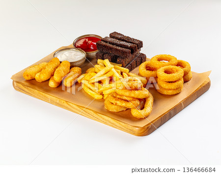 Assorted fried snack platter with onion rings, french fries, cheese sticks, and rye croutons with sauces. 136466684