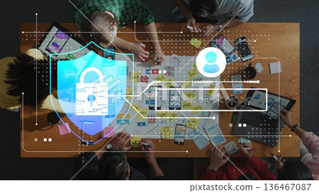 Collaborative Workspace with Digital Security Concept, Team Brainstorming for Innovative Ideas Using Sticky Notes on a Table Overlaid with Cybersecurity Elements Gluon 136467087