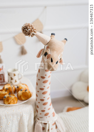 Plush Giraffe Toy With Party Hat At Birthday Celebration Plush Giraffe Toy With Party Hat At Birthday Celebration 136467315