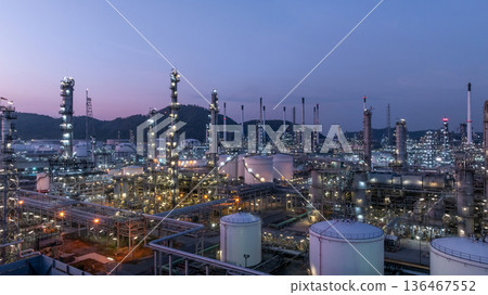 Aerial view oil and gas petrochemical storage tank with oil and gas refinery plant at twilight, Global business power and energy petrochemical industry, Oil and gas refinery petrochemical industrial. 136467552