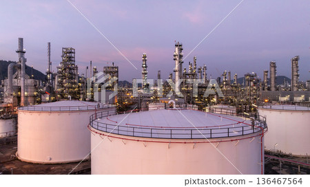 Aerial view oil and gas petrochemical storage tank with oil and gas refinery plant at twilight, Global business power and energy petrochemical industry, Oil and gas refinery petrochemical industrial. 136467564