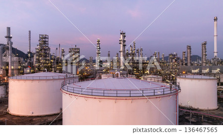 Aerial view oil and gas petrochemical storage tank with oil and gas refinery plant at twilight, Global business power and energy petrochemical industry, Oil and gas refinery petrochemical industrial. 136467565
