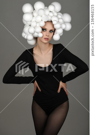 Young woman modeling avant-garde white spheres hairstyle Young woman modeling avant-garde white spheres hairstyle 136468155