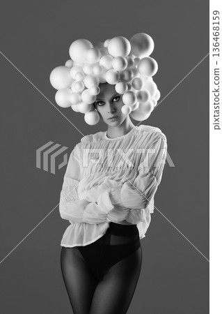 Woman wearing avant-garde bubble headpiece and fashion outfit Woman wearing avant-garde bubble headpiece and fashion outfit 136468159