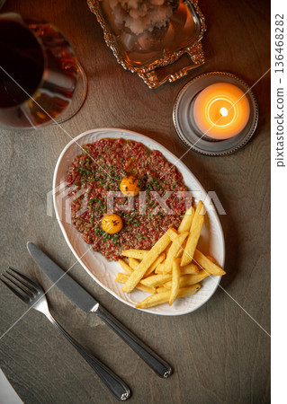 Beef tartare with egg yolk and french fries Beef tartare with egg yolk and french fries 136468282